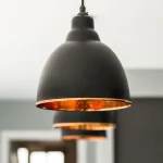 Brindley Pendant Lights in a Row - Warm Glow from Copper Interior